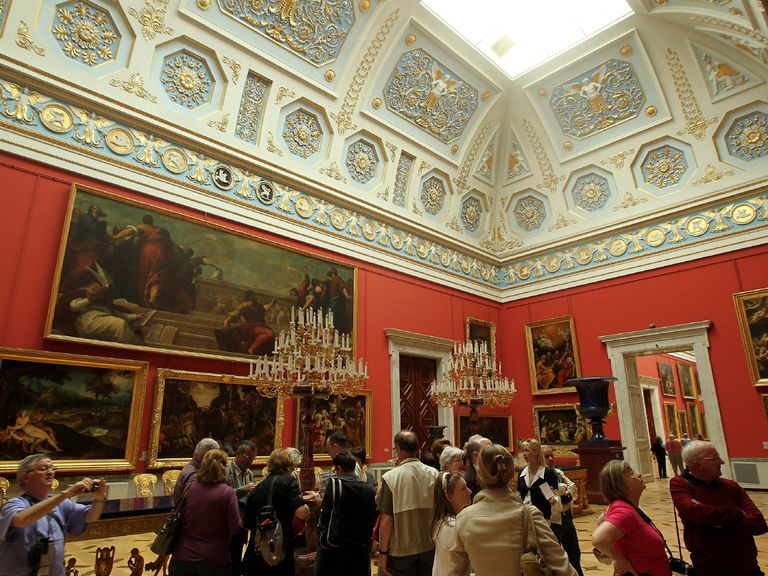 Visitors looking around a museum. Projection and display screens enhance engagement.