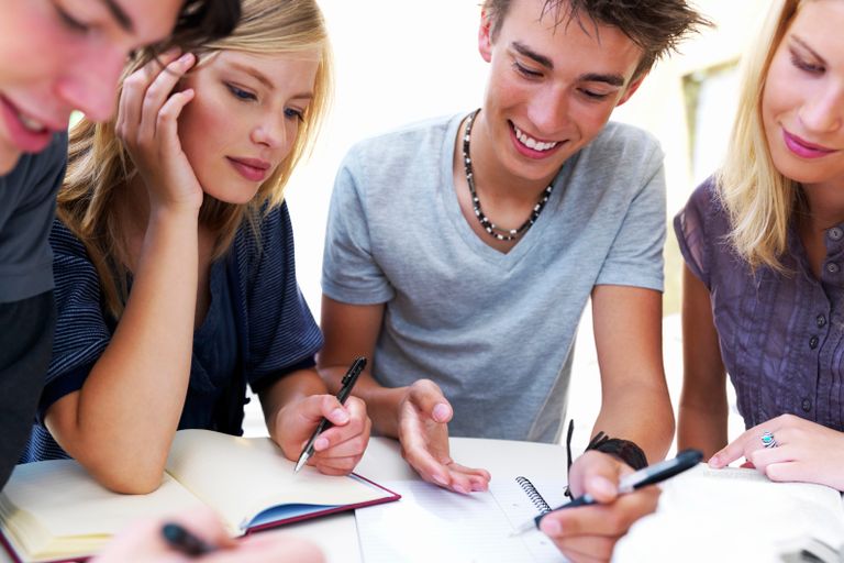 Students collaborating at a table. A great application for large format touch screens.