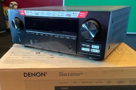 A new Denon AV receiver sitting on it's packaging